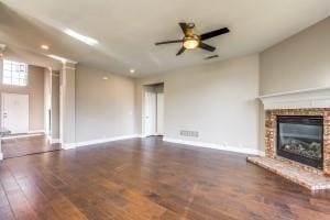2789 Coyote Trl, Little Elm, TX 75068 - unfurnished living room with a ceiling fan, baseboards, wood finished floors, a fireplace, and recessed lighting