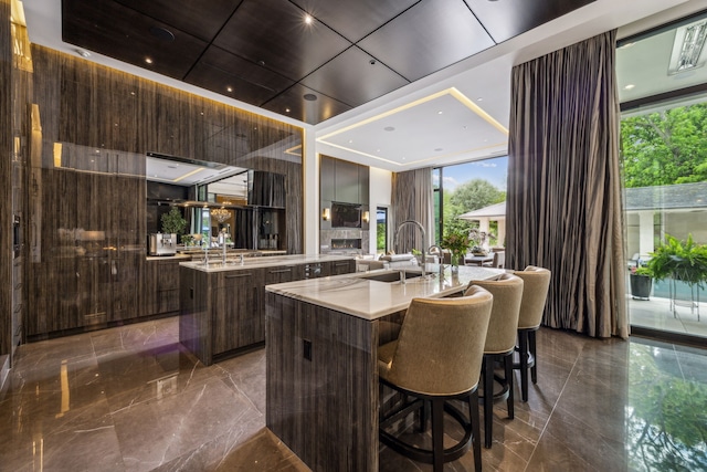 5214 Royal Ln, Dallas, TX 75229 - bar area featuring a sink and dark marble finish floors