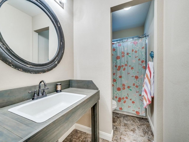 1209 Golden Eagle Ct, Aubrey, TX 76227 - bathroom featuring a sink, toilet, baseboards, and a shower with curtain