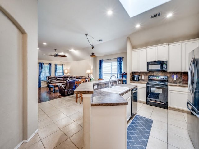 1209 Golden Eagle Ct, Aubrey, TX 76227 - kitchen with black appliances, a sink, light tile patterned floors, decorative backsplash, and open floor plan