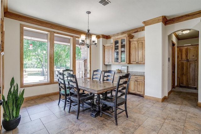 4312 Tapatio Springs Rd, Fort Worth, TX 76108 - dining area featuring arched walkways, baseboards, crown molding, a chandelier, and light stone finish flooring