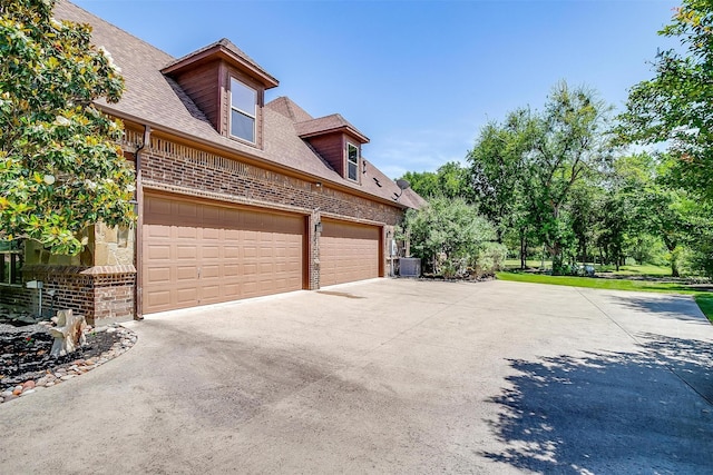 4312 Tapatio Springs Rd, Fort Worth, TX 76108 - view of side of property with brick siding, driveway, central air condition unit, and roof with shingles