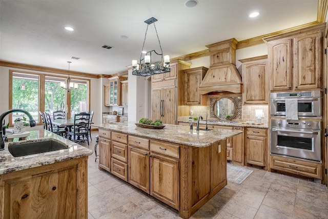 4312 Tapatio Springs Rd, Fort Worth, TX 76108 - kitchen with a chandelier, a sink, an island with sink, light stone counters, and recessed lighting