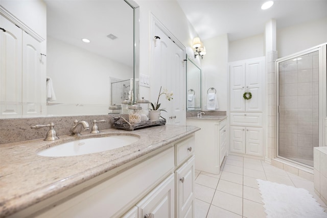 6137 Oram St, Dallas, TX 75214 - full bath featuring a stall shower, tile patterned floors, two vanities, and recessed lighting