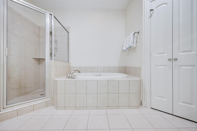 6137 Oram St, Dallas, TX 75214 - bathroom featuring a bath, a shower stall, tile patterned flooring, and a closet