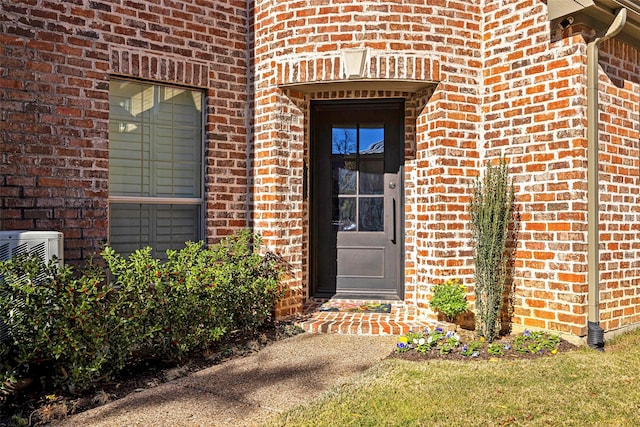6137 Oram St, Dallas, TX 75214 - doorway to property featuring brick siding