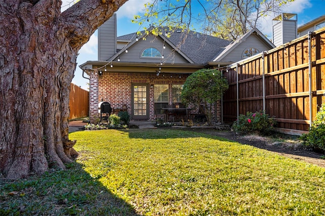 6137 Oram St, Dallas, TX 75214 - back of property featuring brick siding and roof with shingles