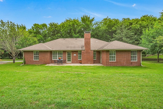 289 Cates Rd, Van Alstyne, TX 75495 - back of property featuring a patio, a chimney, a yard, and brick siding