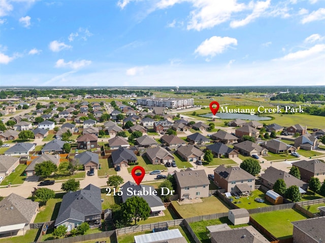 aerial perspective of suburban area featuring a nearby body of water