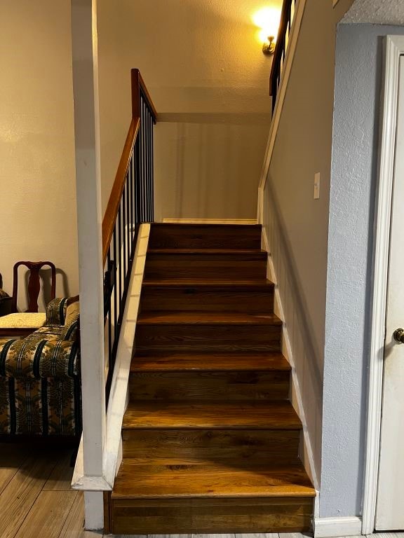 stairway with wood finished floors