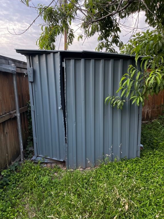 view of shed with fence