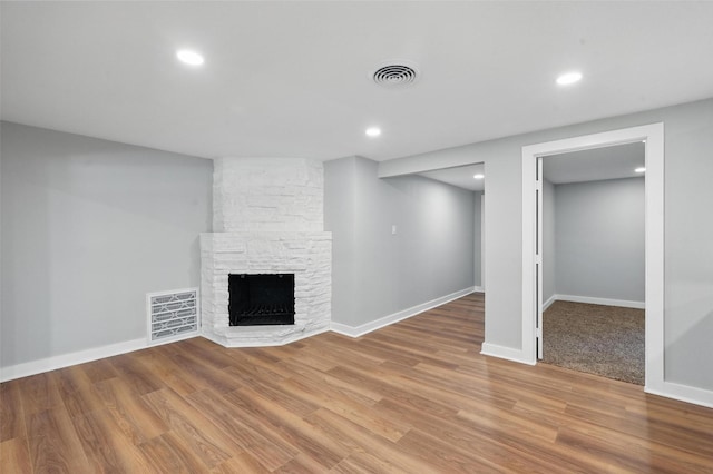 1220 Brittany Ln, Arlington, TX 76013 - unfurnished living room featuring wood finished floors, a stone fireplace, recessed lighting, and baseboards