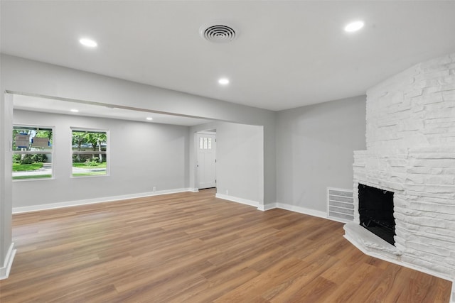 1220 Brittany Ln, Arlington, TX 76013 - unfurnished living room featuring light wood-style floors, a large fireplace, recessed lighting, and baseboards