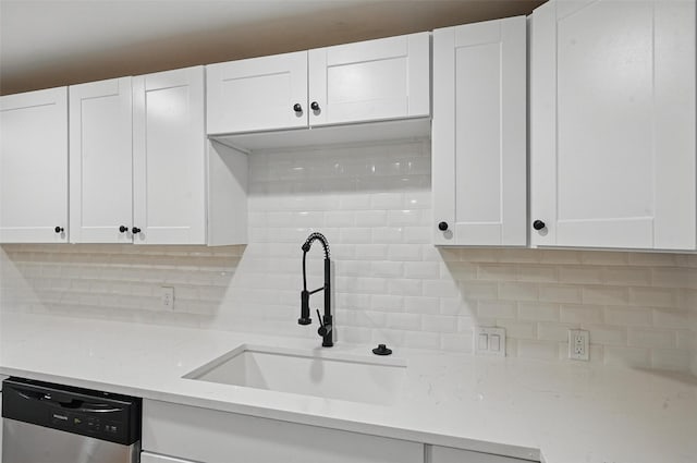 1220 Brittany Ln, Arlington, TX 76013 - kitchen featuring a sink, dishwasher, backsplash, white cabinetry, and light stone countertops
