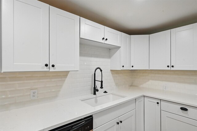 1220 Brittany Ln, Arlington, TX 76013 - kitchen featuring a sink, tasteful backsplash, and white cabinetry