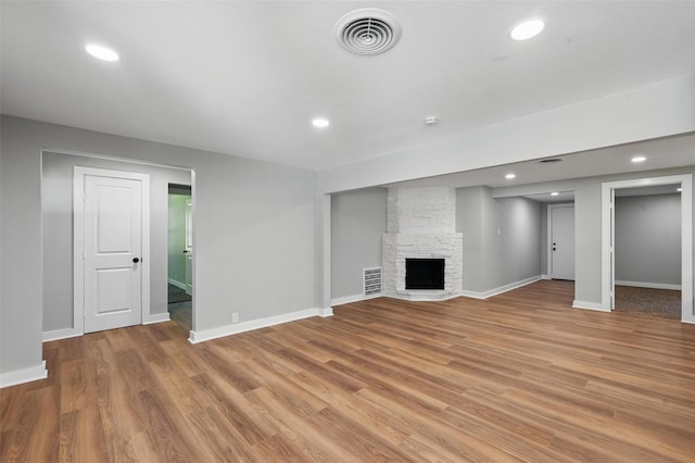 1220 Brittany Ln, Arlington, TX 76013 - basement featuring light wood-style floors, baseboards, a stone fireplace, and recessed lighting