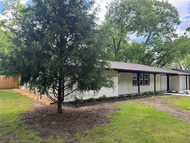 1220 Brittany Ln, Arlington, TX 76013 - view of front of house featuring an attached garage and dirt driveway