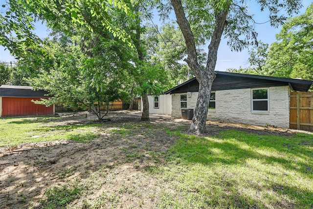 1220 Brittany Ln, Arlington, TX 76013 - back of house with central AC and stone siding