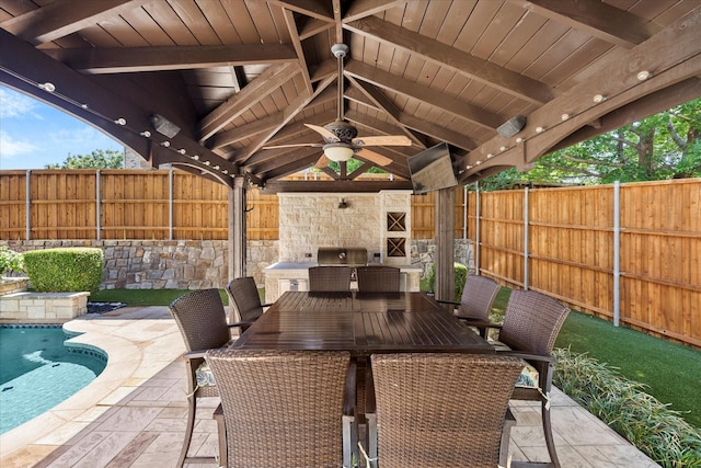 227 Justin Rd, Murphy, TX 75094 - fenced backyard with ceiling fan, a gazebo, exterior kitchen, a patio area, and outdoor dining space