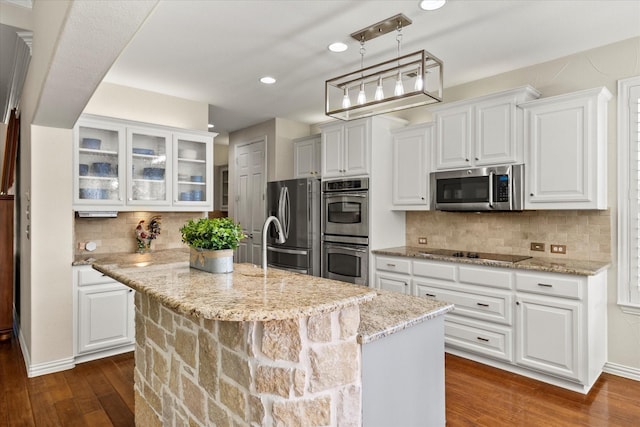 227 Justin Rd, Murphy, TX 75094 - kitchen with appliances with stainless steel finishes, dark wood finished floors, white cabinetry, glass insert cabinets, and recessed lighting