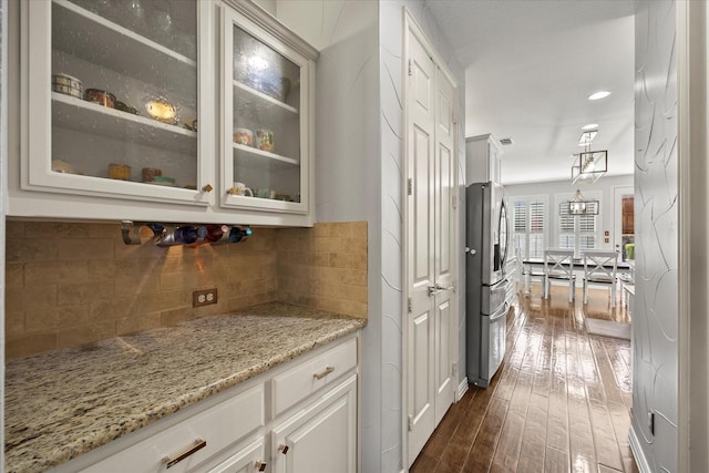 227 Justin Rd, Murphy, TX 75094 - bar area featuring dark wood finished floors, tasteful backsplash, and stainless steel fridge with ice dispenser