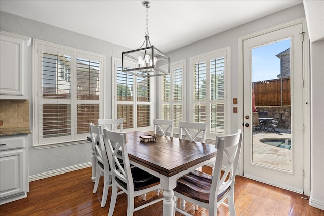 227 Justin Rd, Murphy, TX 75094 - dining room with a chandelier, wood finished floors, and baseboards