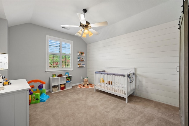 227 Justin Rd, Murphy, TX 75094 - bedroom featuring vaulted ceiling, a nursery area, carpet floors, a ceiling fan, and wood walls