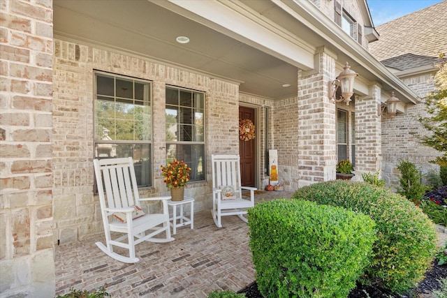 227 Justin Rd, Murphy, TX 75094 - entrance to property featuring a porch, brick siding, and a shingled roof