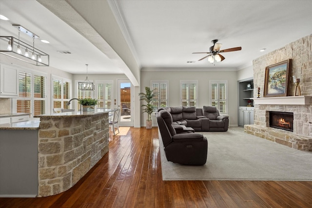 227 Justin Rd, Murphy, TX 75094 - living area featuring a fireplace, dark wood-style floors, ceiling fan, baseboards, and ornamental molding