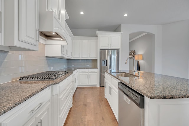 14937 Belclaire Ave, Aledo, TX 76008 - kitchen featuring appliances with stainless steel finishes, a sink, arched walkways, white cabinetry, and light wood finished floors
