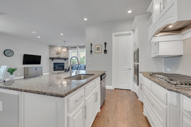 14937 Belclaire Ave, Aledo, TX 76008 - kitchen featuring a sink, appliances with stainless steel finishes, a ceiling fan, white cabinetry, and backsplash