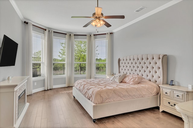 14937 Belclaire Ave, Aledo, TX 76008 - bedroom with crown molding, light wood-style flooring, baseboards, ceiling fan, and a glass covered fireplace