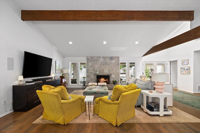 living room with high vaulted ceiling, beamed ceiling, dark wood finished floors, a high end fireplace, and healthy amount of natural light