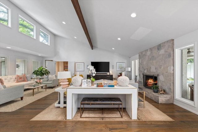 living area with wood finished floors, a fireplace, recessed lighting, beamed ceiling, and high vaulted ceiling