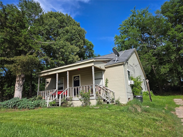 904 Church St, Winnsboro, TX 75494 - view of front of house with covered porch, a front lawn, and roof with shingles