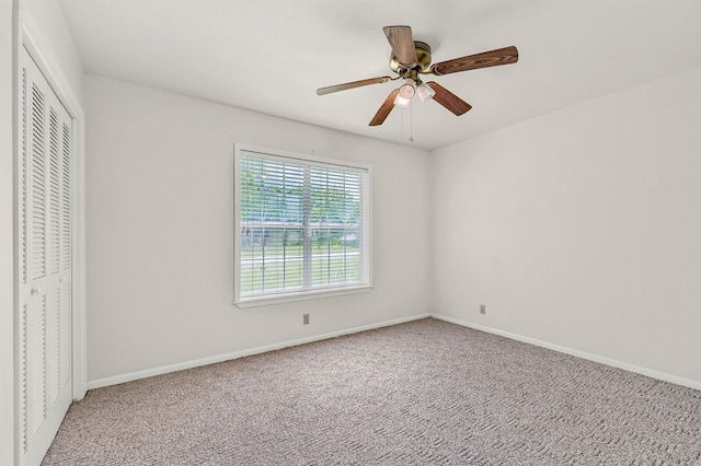 unfurnished bedroom with carpet flooring, baseboards, and a closet