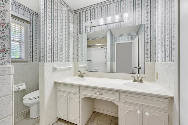 full bathroom featuring tile walls, tile patterned flooring, toilet, a shower stall, and wainscoting