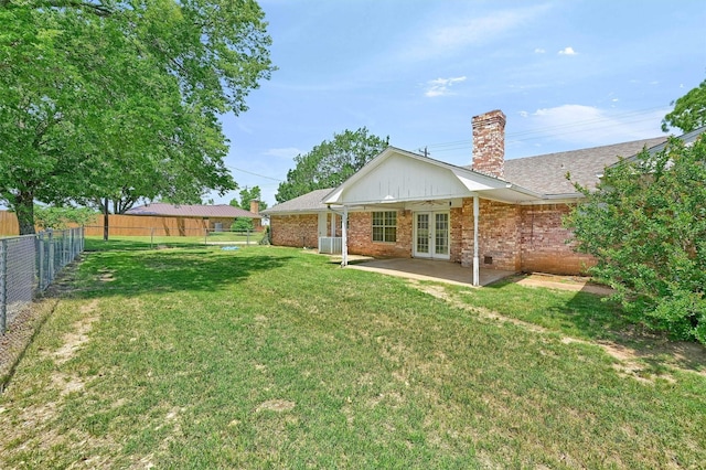 back of house with french doors, a chimney, central AC unit, a patio, and brick siding