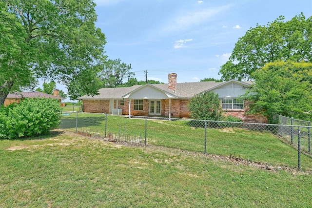 view of front facade with a chimney, french doors, and brick siding