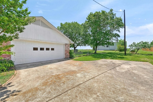 garage featuring concrete driveway