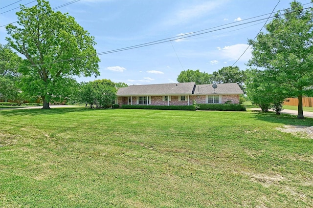 ranch-style house with a front lawn and brick siding