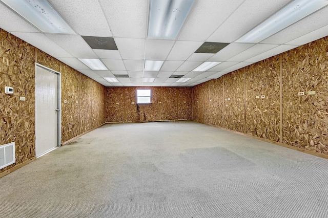 empty room featuring carpet flooring and a drop ceiling