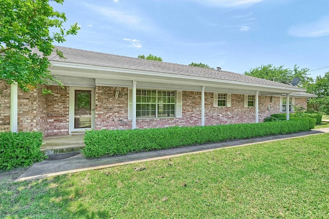 ranch-style home featuring a front yard, a porch, and brick siding