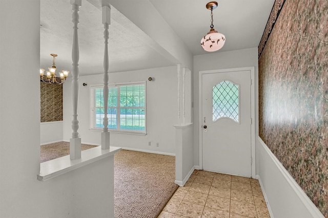 entryway featuring a chandelier and baseboards