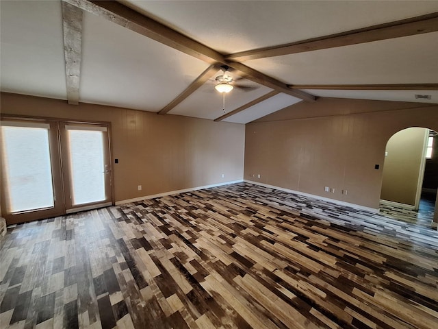 unfurnished room featuring wood finished floors, arched walkways, ceiling fan, and baseboards