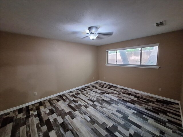 unfurnished room featuring baseboards and wood finished floors