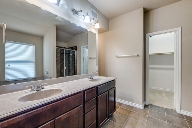 5844 Sunny Meadow Ln, Grand Prairie, TX 75052 - full bath with a shower stall, tile patterned flooring, a walk in closet, double vanity, and baseboards