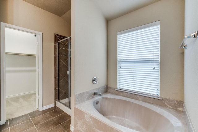 5844 Sunny Meadow Ln, Grand Prairie, TX 75052 - full bath featuring a shower stall, a walk in closet, tile patterned flooring, and a bath