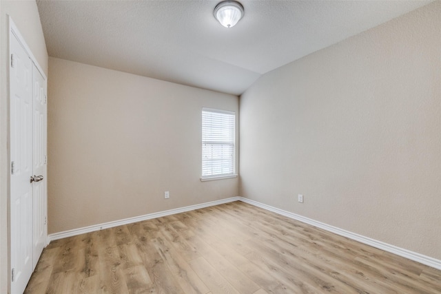 5844 Sunny Meadow Ln, Grand Prairie, TX 75052 - spare room featuring light wood-style flooring, baseboards, and lofted ceiling