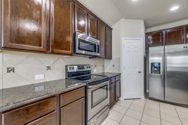 5844 Sunny Meadow Ln, Grand Prairie, TX 75052 - kitchen featuring stainless steel appliances, dark stone countertops, dark brown cabinets, light tile patterned floors, and decorative backsplash